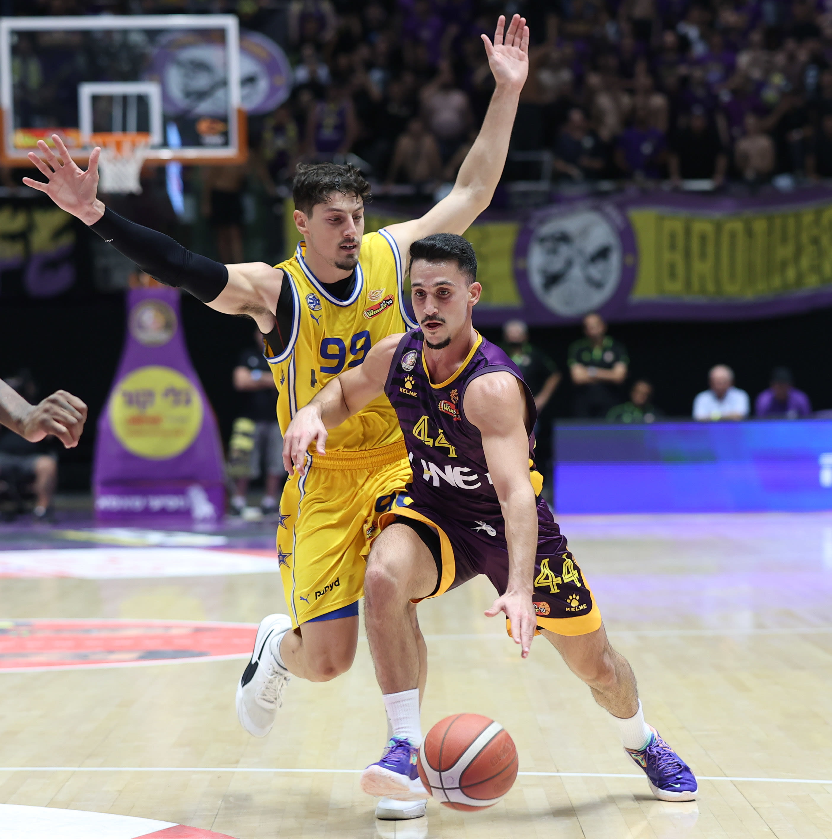 ניב משגב, שחקן הפועל חולון, עובר את יפתח זיו, שחקן מכבי תל אביב