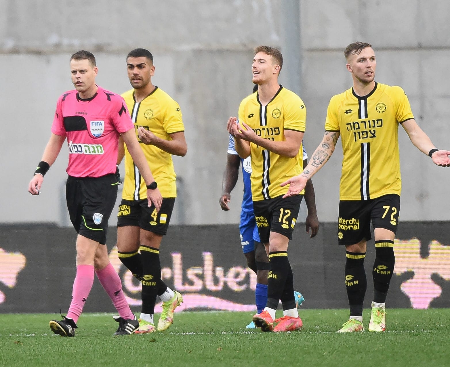 יובל שדה שחקן מכבי נתניה עם השופט יגאל פריד