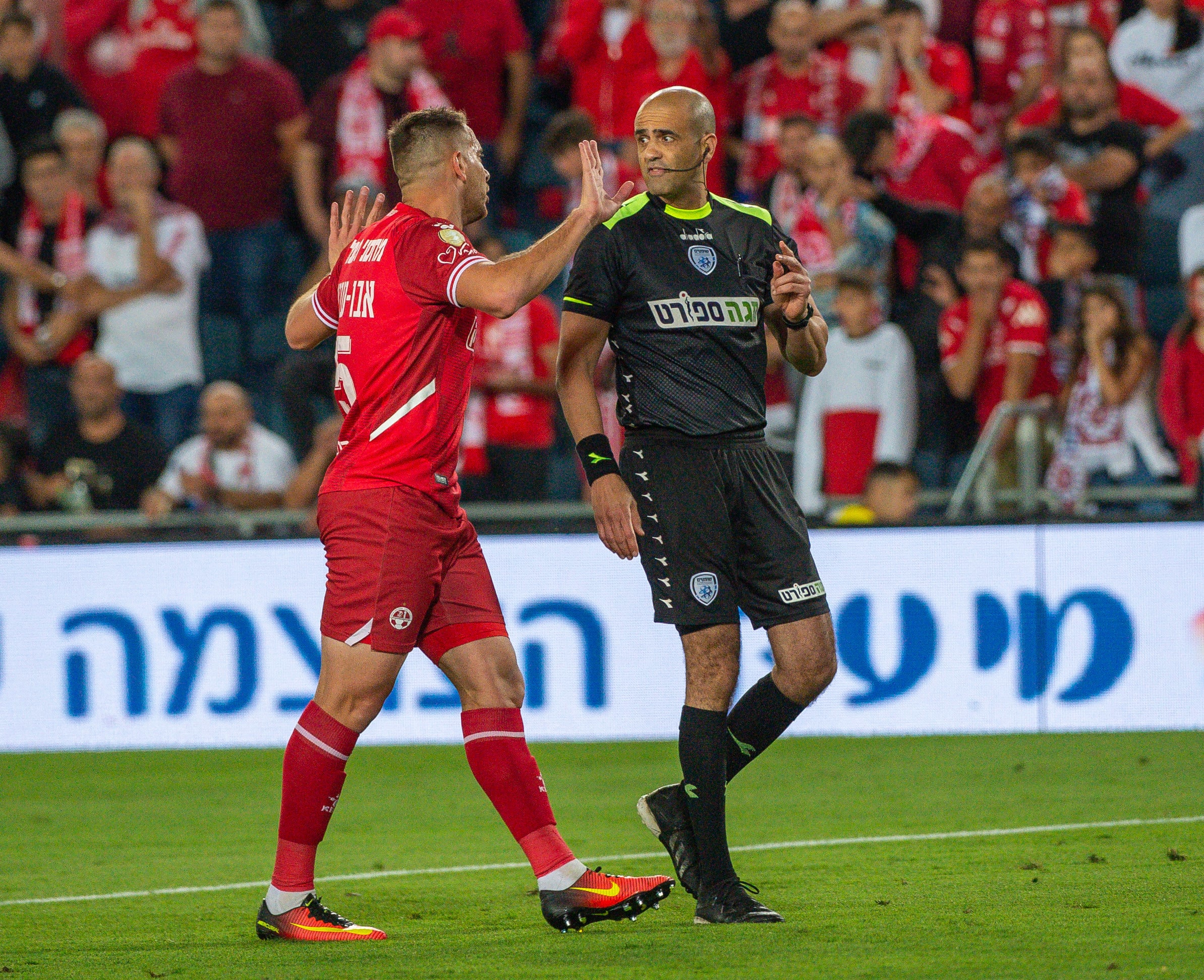 שחקן הפועל באר שבע איאד אבו עביד עם השופט דניאל בר נתן