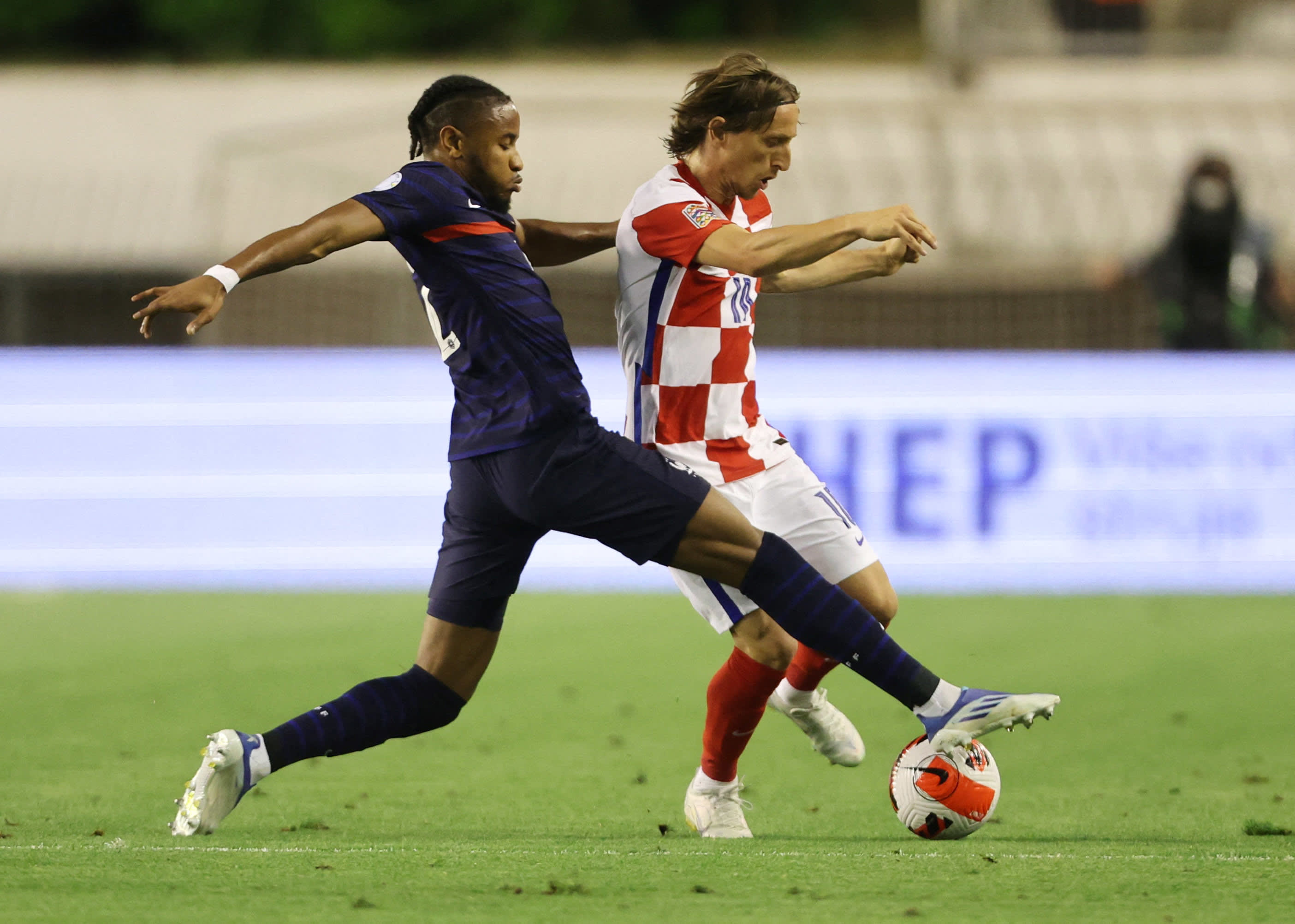 Luca Modric is a member of the Croatia national team against Christopher Anconco, a member of the French national team