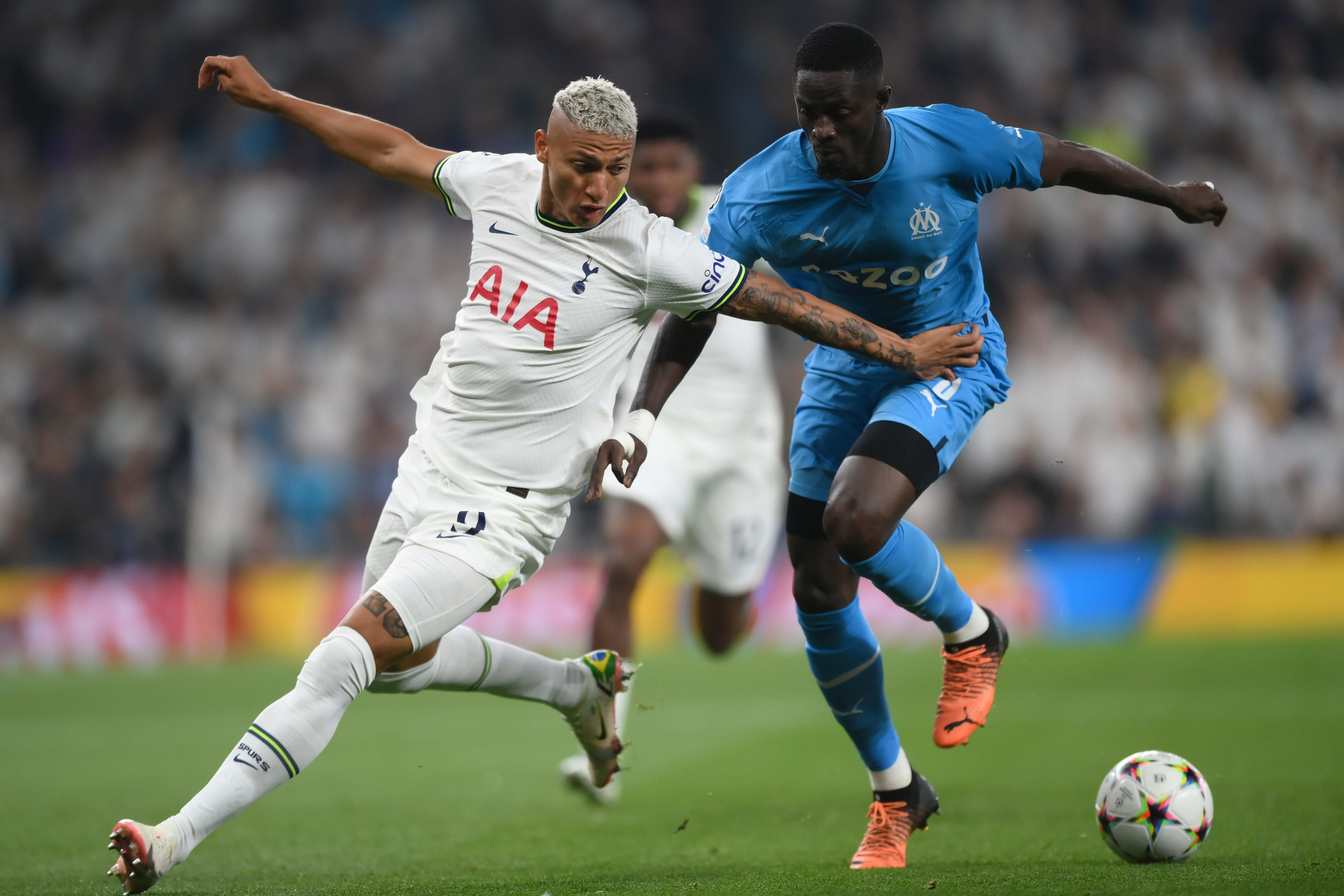 Marseille defender Eric Bailly in front of Richarlison, a Tottenham player