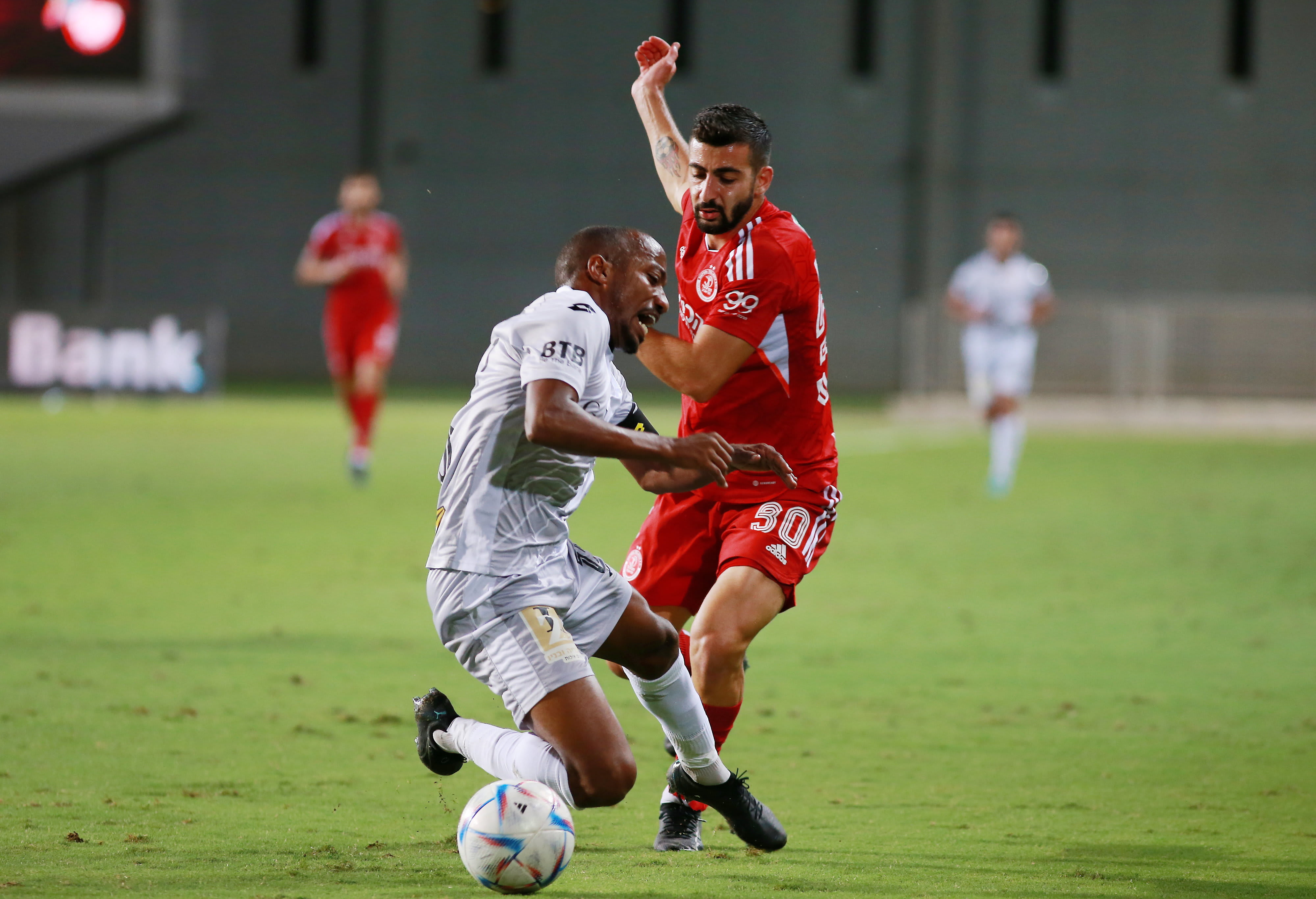 Hapoel Tel Aviv player Hisham Laios against Hapoel Hadera player Menashe Zalka