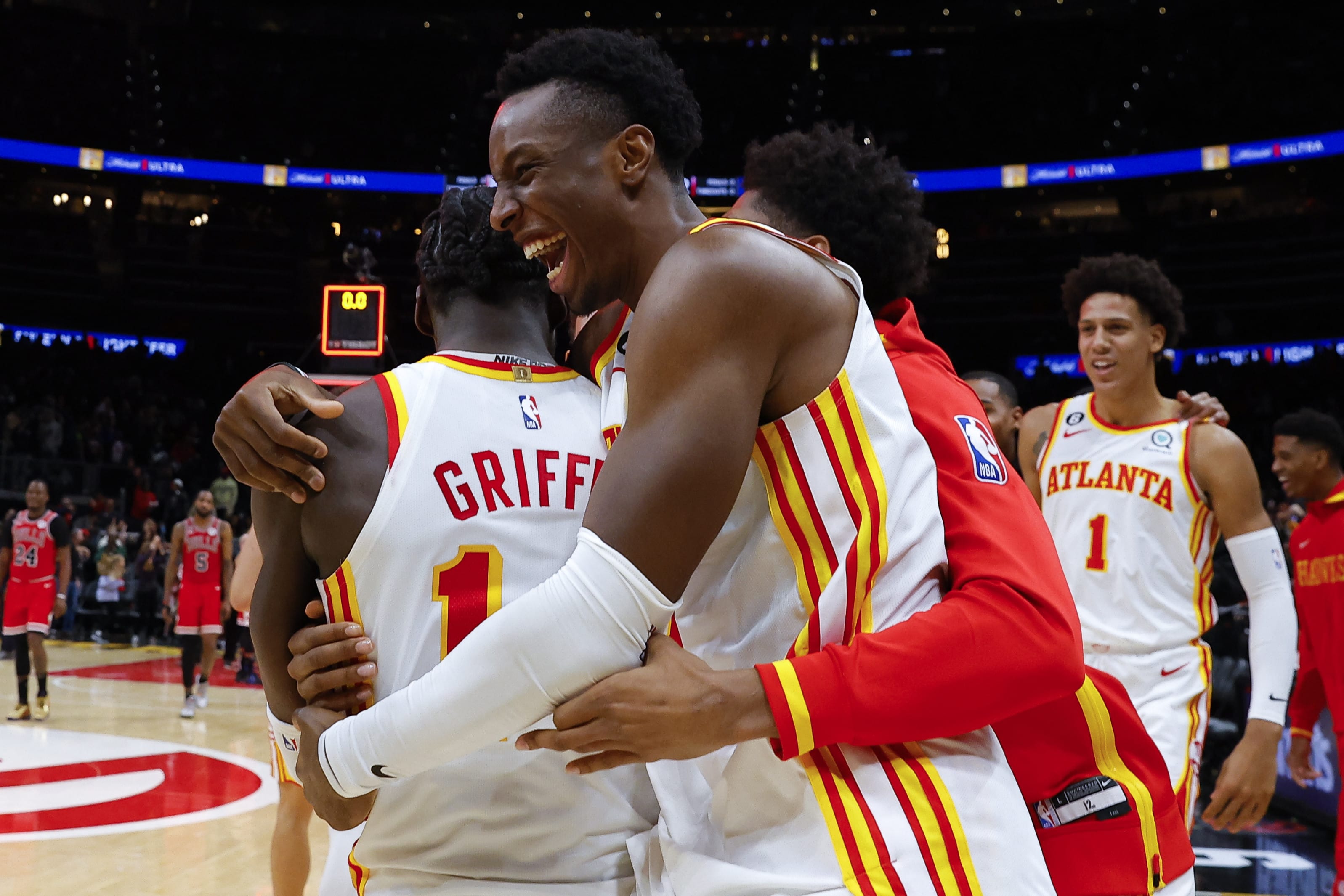 Atlanta Hawks players celebrate the winning basket with AJ Griffin