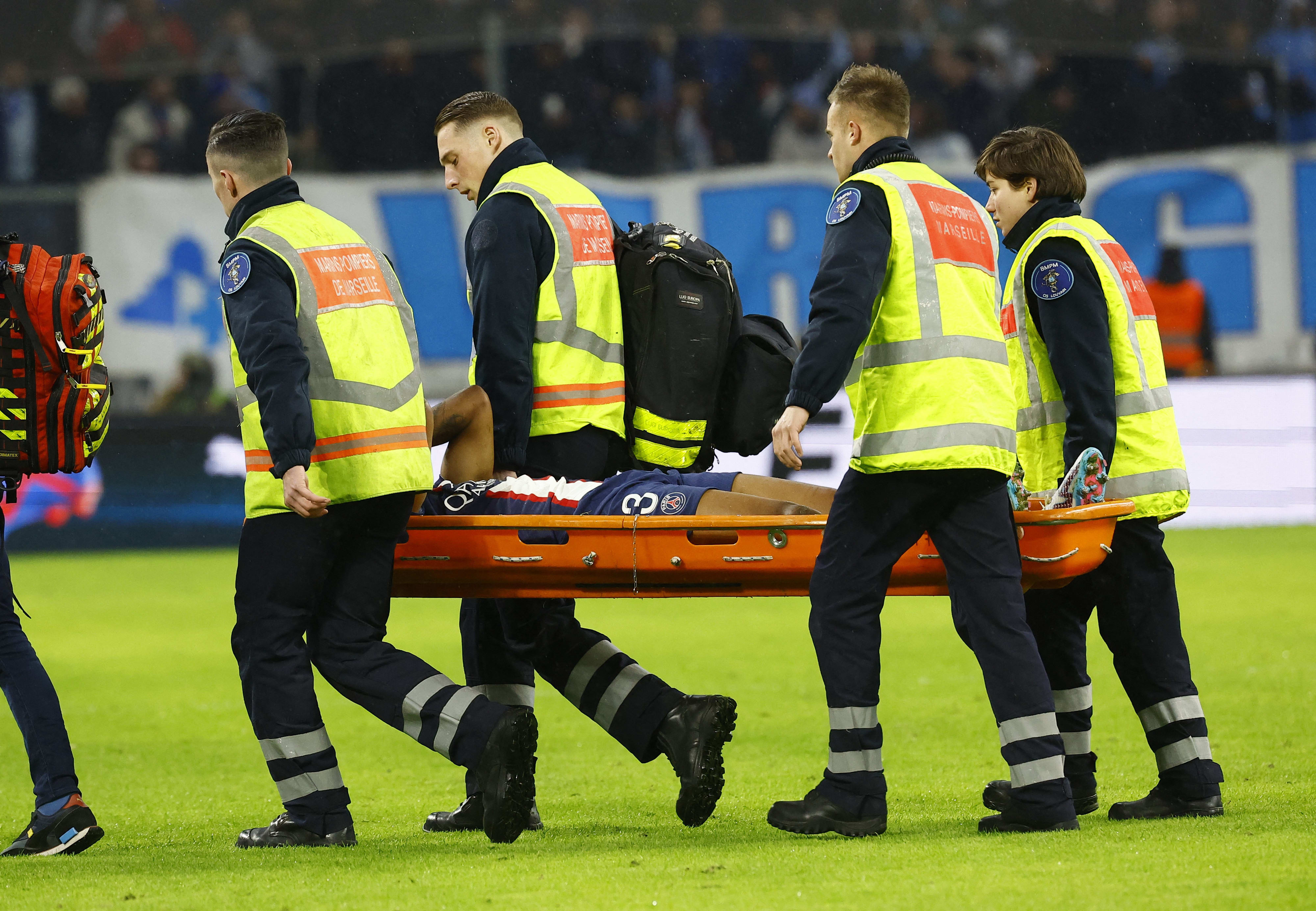Paris Saint-Germain player Presnel Kimpamba is evacuated on a stretcher