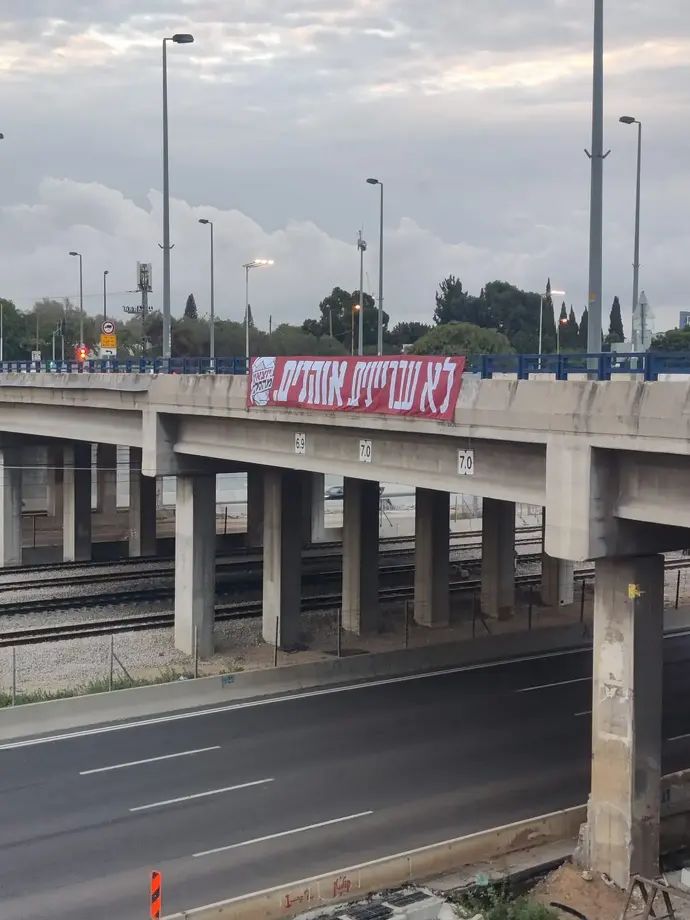 שלטים עם הכיתוב "לא עבריינים. אוהדים"