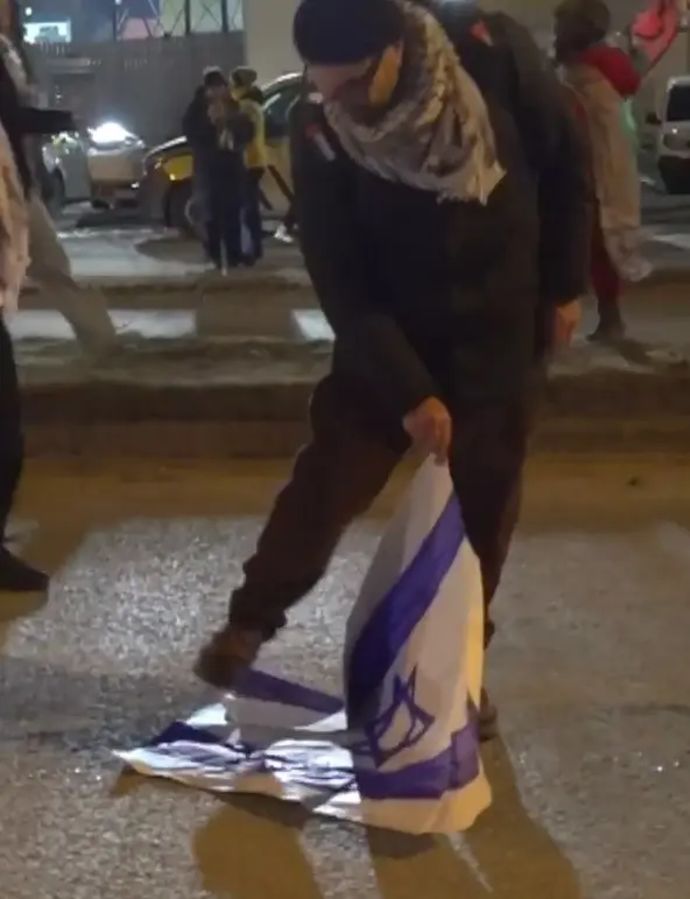 מפגין פרו-פלסטיני דורך ויורק על דגל ישראל בזמן משחקה של מכבי תל אביב מול בודה גלימט