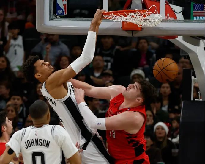 שחקן סן אנטוניו ספרס ויקטור וומבניאמה מטביע מול שחקן פורטלנד טריילבלייזרס דונובן קלינגן