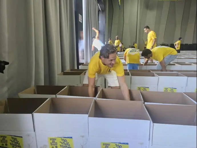שחקן מכבי תל אביב איתמר נוי באירוע אריזות חבילות מזון